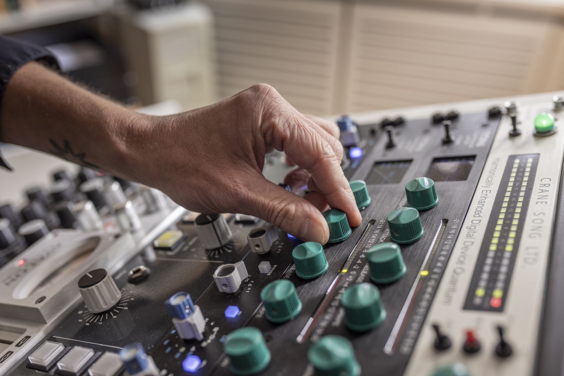 Hand turning a knob on the Crane Song compressor